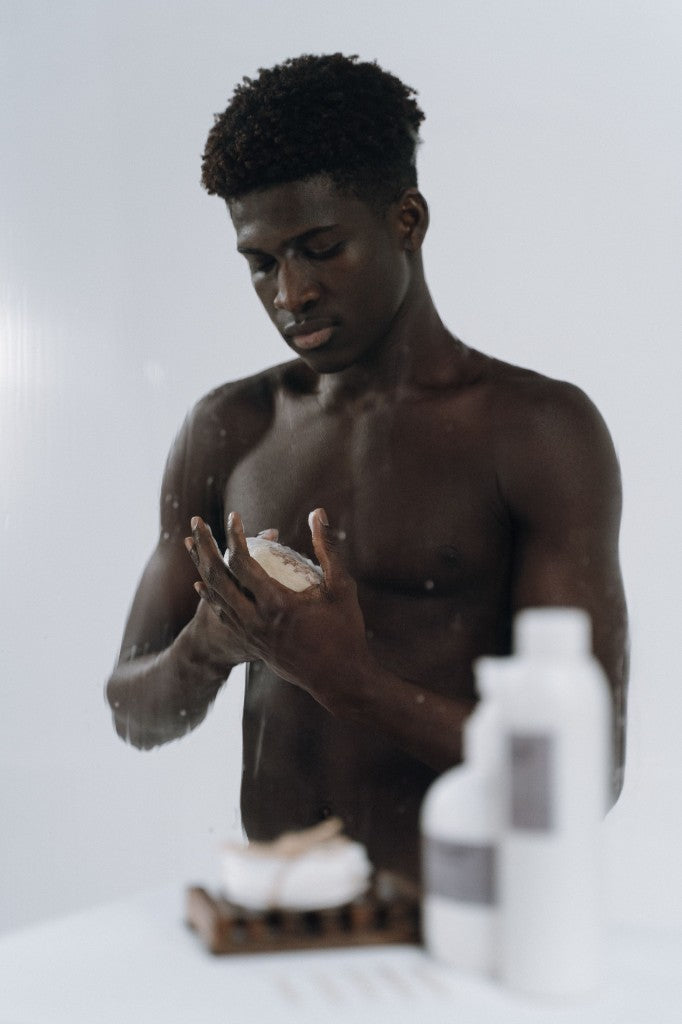 Man holding a bar of soap in a quiet bathroom moment
