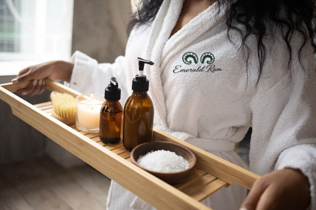 Bath shelf with botanical soaps, brush, and amber bottles